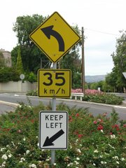 Australian speed advisory sign above a keep left sign