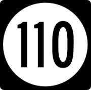 A circular highway shield for route 110