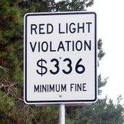 One way to discourage red light running is to post the minimum fine on large signs at major intersections.