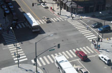 Intersection of 4th and San Fernando in San Jose, California. The intersection has crosswalks, left-turn lanes, and traffic lights.