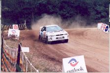 A Subaru Impreza rally car uses 4WD for traction on loose dirt.