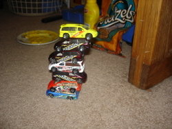 A stack of Hot Wheels toy Dodge Caravans