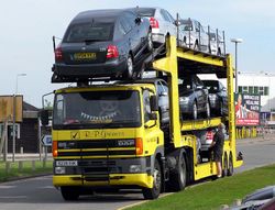 The driver of this DAF tractor with an auto-transport semi-trailer prepares to offload Skoda Octavia cars in Cardiff, Wales