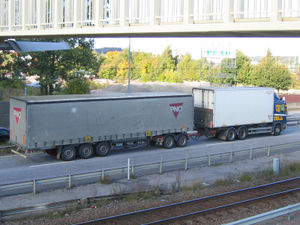 A truck pulling a trailer using a trailer dolly.