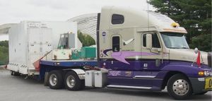 semi-trailer truck with 'sleeper' behind the cab.