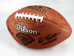 The ball used in American football has a pointed oval or vesica piscis shape, and usually has a large set of stitches along one side.