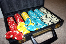 A set of poker chips with denominations 100, 50, 25 & 10