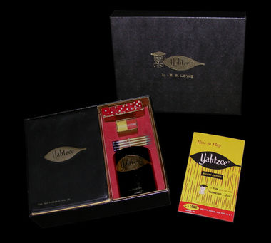 1961 Yahtzee Deluxe Edition with scorepad covers, leather dice cup, and black leather-grain box.