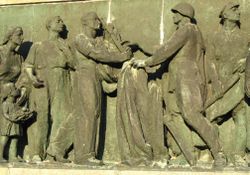 A relief from the Soviet military cemetery in Warsaw showing workers greeting victorious soldiers.