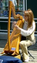 A street musician in Quebec City plays the lever harp