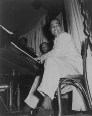 Duke Ellington straddled the big band and bebop genres.  Though clearly a jazz artist, he used the blues form extensively.