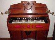 A harmonium. Notice the two large pedals at the bottom of the case; operating these pedals supplies wind to the reeds.