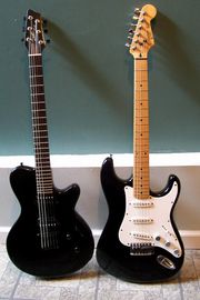 Both the North America-built Godin LG (left) and the Fender Stratocaster (right - an entry-level, Korean-made Squier model is shown) are solidbody electric guitars, but they differ significantly in design, including scale length, neck and body woods, and pickup type.