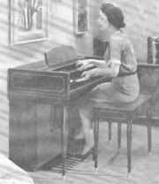 A typical spinet organ of the 1950s. Note the resemblance in size and shape to a small home piano. Note also the shortened, offset manuals and miniature pedalboard, both sure signs of the spinet.